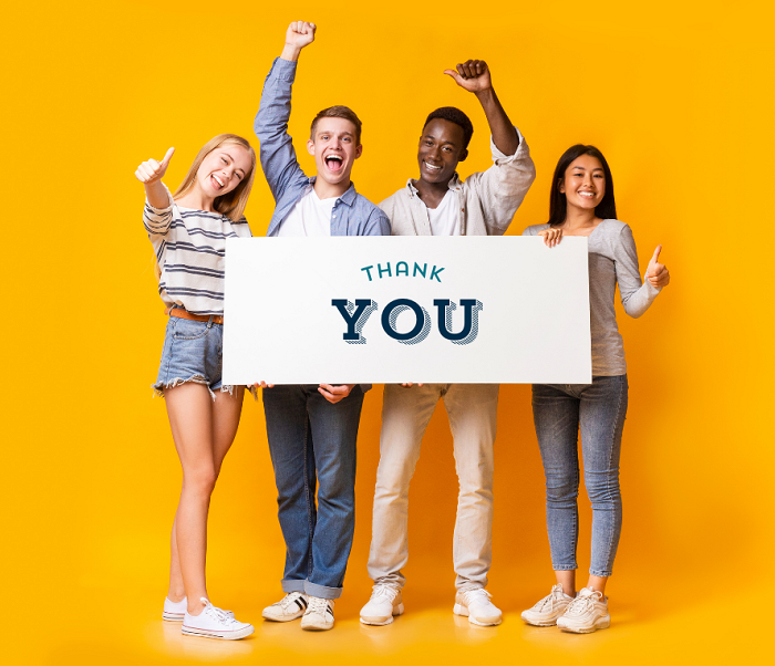 Four young people holding a banner that says 'Thank you'