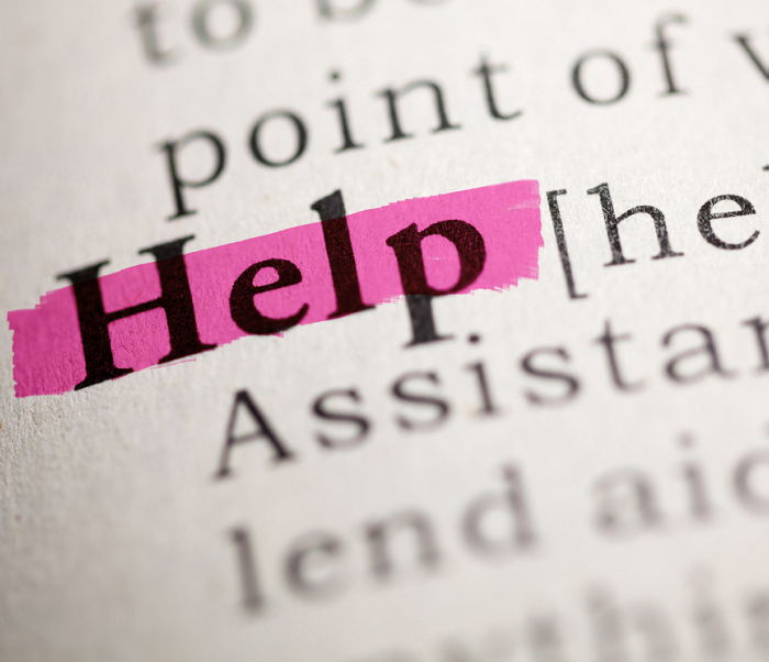 The word 'help' highlighted on a page in a book